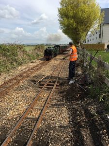 Working on the track as a train goes by
